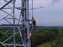 A vendor climbs one of the CCI towers.